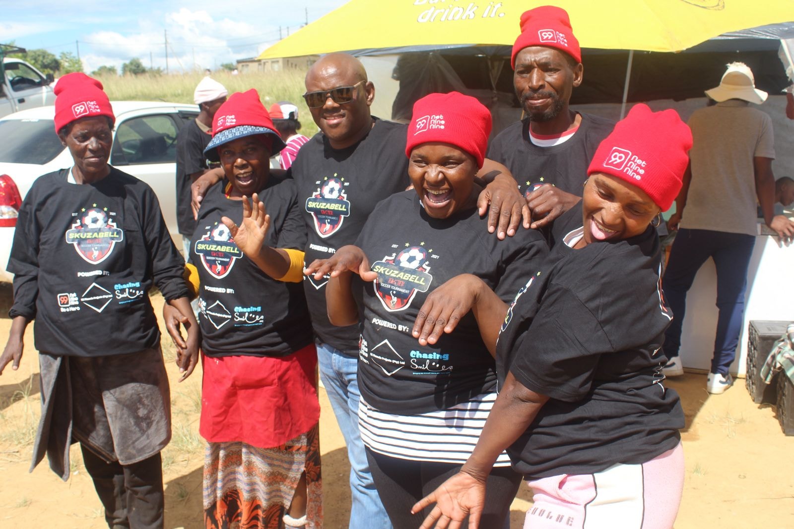 Community members in branded apparel at an outdoor event