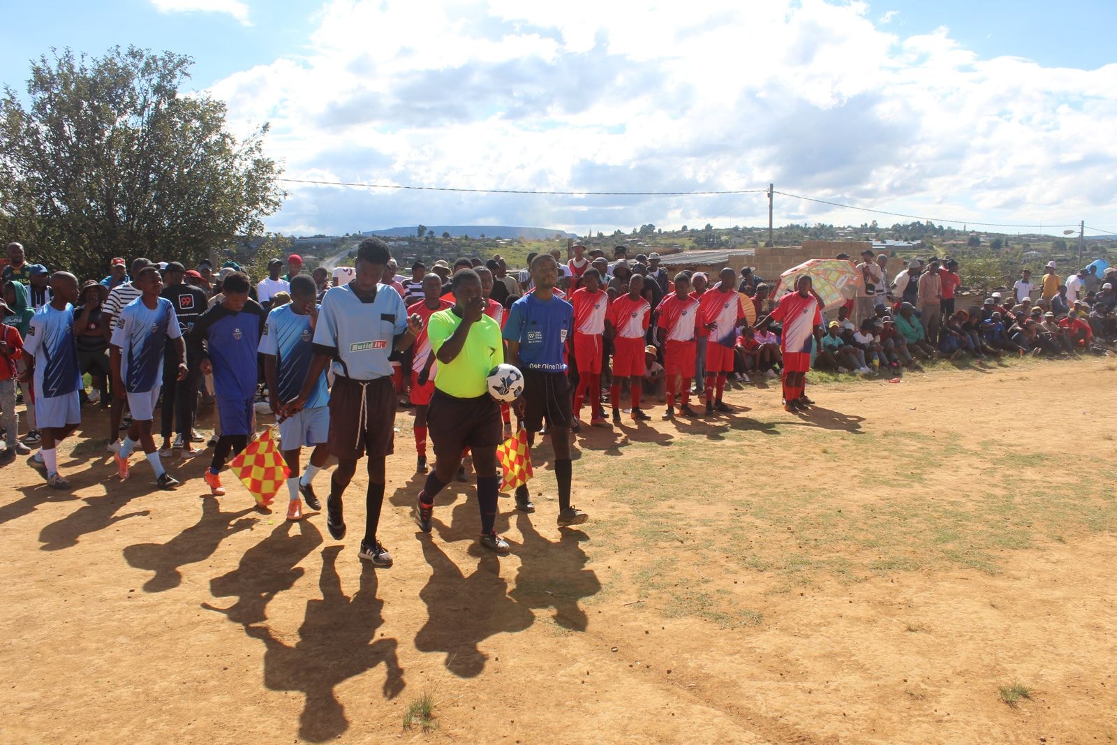 Youth soccer teams walking onto the field for a match